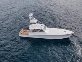 A stunning aerial view of a sleek yacht cruising through open waters, showcasing its elegant design and perfect for luxury charters.