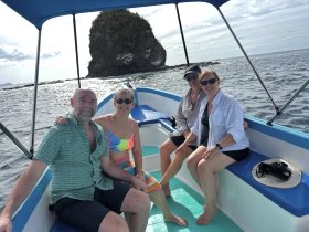 A cheerful group of friends enjoys a day on the water, capturing the essence of adventure and camaraderie aboard their boat.