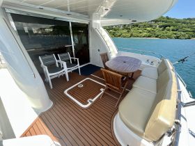 The interior of a luxurious yacht features a cozy dining area with elegant seating, perfect for enjoying meals while cruising on the water.