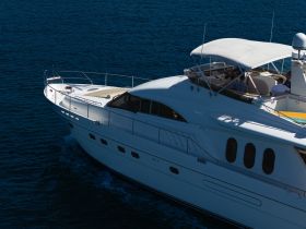 A luxurious yacht cruising through deep blue waters, with guests enjoying the ride — perfect for upscale boating experiences.
