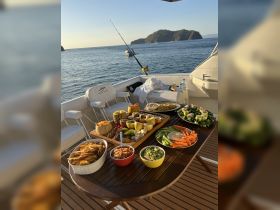 A beautifully arranged spread of snacks and refreshments on a boat, perfect for enjoying a day on the water with friends or family.