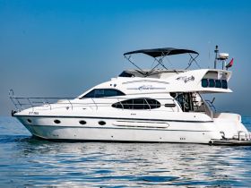 A stunning side view of a luxurious yacht docked in calm waters, showcasing its elegant design and perfect for upscale boating experiences.