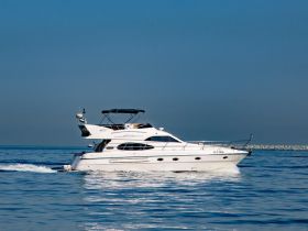 A stunning yacht glides through calm waters, showcasing its elegant design and perfect for luxurious outings on the sea.