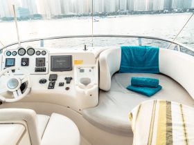 A well-appointed helm area of a boat featuring modern controls and comfortable seating, perfect for navigating the waters in style.