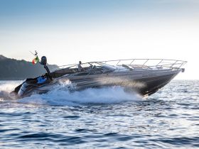 A sleek Riva speedboat cuts through the water, showcasing its elegant design and powerful performance. Perfect for thrilling adventures on the open sea.