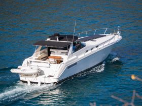 A sleek yacht cruising through clear waters, showcasing its elegant design and spacious layout — perfect for luxury outings on the water.