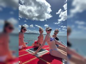 A group of friends enjoys a sunny day on a boat, capturing the essence of fun and relaxation on the water. Perfect for memorable outings and celebrations.