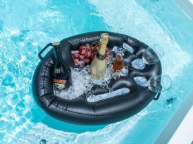 A stylish floating cooler holds drinks and grapes, perfect for enjoying refreshing cocktails while relaxing in the pool.