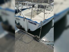 A close-up view of the boat named 'TRANXENE' docked at the marina, showcasing its structure and details.