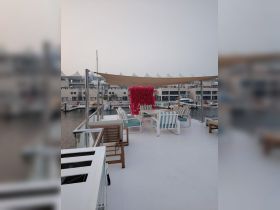 A beautifully designed lounge area on a boat, featuring comfortable seating and a stylish decor, perfect for relaxation and social gatherings on the water.