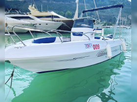 A sleek boat docked in tranquil waters, showcasing its elegant design and perfect for leisurely outings or tours.