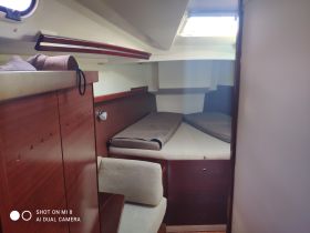 A cozy interior view of a boat cabin featuring comfortable seating and sleeping areas, perfect for relaxing during a sailing trip.