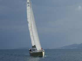 A sleek sailboat glides through the water, showcasing its elegant design and the thrill of sailing. Perfect for adventure seekers and sailing enthusiasts.