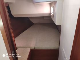 Cozy cabin interior featuring a comfortable sleeping area, perfect for relaxing on overnight boating trips.