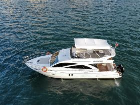 A stunning aerial view of the yacht 'Viktoria' docked in serene waters, showcasing its elegant design and spacious layout, perfect for luxury charters.