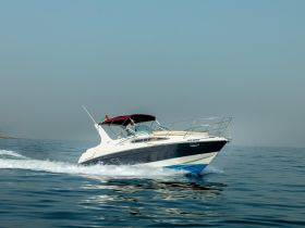 A sleek speedboat glides through calm waters, showcasing its elegant design and performance — perfect for thrilling adventures on the sea.