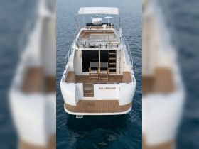 A stunning aerial view of the 'HEDONIST' yacht, showcasing its elegant design and spacious deck, perfect for luxurious outings on the water.