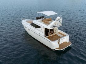 A stunning aerial view of a luxurious yacht, showcasing its sleek design and spacious deck, perfect for relaxing on the water.