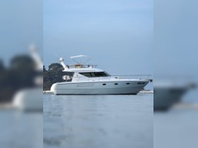 A sleek yacht is docked peacefully, showcasing its elegant design against a serene backdrop — perfect for luxury boating experiences.
