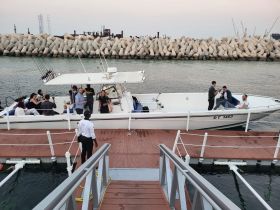 A lively group enjoys their time aboard a boat at the dock, perfect for celebrations and social gatherings on the water.