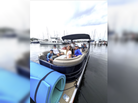 A cheerful group of friends and family enjoys a day on a pontoon boat, perfect for creating lasting memories on the water.