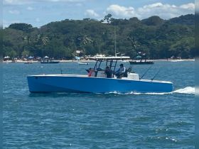 A sleek speedboat navigates through clear waters, showcasing its modern design and perfect for thrilling adventures on the sea.