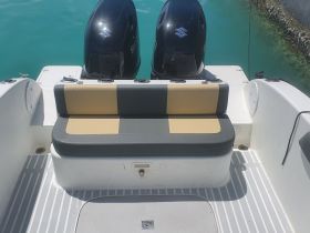 Interior view of a boat's seating area, showcasing comfortable seating and a clean layout — ideal for relaxing while on the water.
