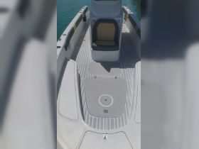 Interior view of a boat's helm and seating area, showcasing a clean and spacious layout ideal for comfortable cruising.