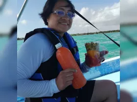 A woman enjoys refreshing snacks and drinks while aboard a boat, perfect for a day on the water.