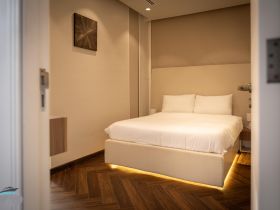 A cozy and modern cabin interior featuring a comfortable bed, perfect for relaxing on a boat getaway.