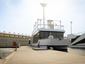 A sleek yacht docked at the marina, showcasing its modern design and spacious deck, perfect for luxury outings.