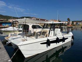A sleek speedboat docked at the marina, showcasing its modern design and spacious seating, perfect for day trips on the water.