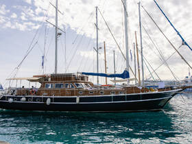A beautiful yacht docked in clear waters, showcasing its elegant design and spacious deck, perfect for luxury charters and sailing adventures.
