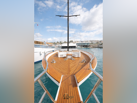 A stunning view of a luxurious yacht's bow, showcasing its elegant wooden deck and stylish seating area, perfect for relaxing on the water.