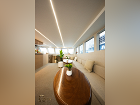 A stylish interior view of a boat's lounge area featuring comfortable seating and modern decor, perfect for relaxing during a day on the water.