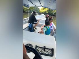 A family enjoys a boat ride through scenic waters, creating lasting memories with children on board.