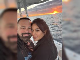 A couple enjoys a romantic moment at sunset on a boat, capturing the perfect backdrop for memorable celebrations on the water.