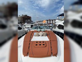 A cozy lounge area on a boat featuring plush cushions and a stylish layout, perfect for relaxing on the water.