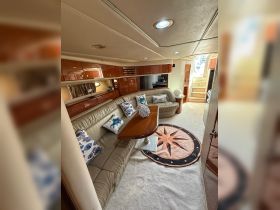 Cozy interior of a yacht featuring a spacious lounge area with comfortable seating and elegant decor, perfect for relaxing during your boating adventures.
