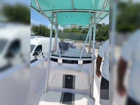 An interior view of a boat's helm and seating area, showcasing the modern design and features ideal for navigation and comfort.