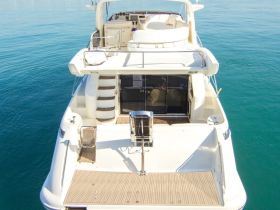 A stunning aerial view of a luxurious yacht docked in calm waters, showcasing its elegant design and spacious deck — perfect for serene getaways.