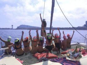 A lively group of friends celebrates on the deck of a yacht, enjoying the sun and each other's company — perfect for a fun day out on the water.