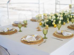 Elegant table setting aboard a boat, featuring beautiful floral arrangements and stylish glassware, perfect for upscale dining experiences on the water.
