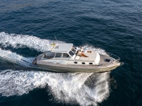 A couple enjoys a scenic ride on a sleek yacht, creating the perfect backdrop for a memorable day on the water.