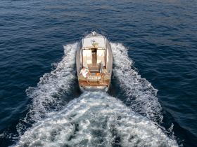A sleek speedboat glides through the water, showcasing an exhilarating day on the waves — perfect for adventure seekers and water enthusiasts.