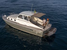A couple enjoys a relaxing moment aboard a stylish yacht, perfect for sun-soaked adventures on the water.