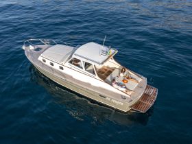 A couple enjoys a relaxing moment on the deck of a stylish yacht, perfect for intimate getaways or leisurely days on the water.