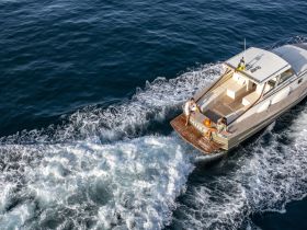 A couple enjoys a relaxing moment on the back of a sleek boat, creating a perfect backdrop for memorable on-water experiences.