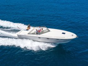 A lively group enjoys a thrilling ride on a speedboat, cutting through the vibrant blue waters — perfect for adventure seekers and fun on the water.
