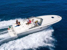 A lively group enjoys a thrilling ride on a speedboat, showcasing the joy of on-water activities and fun in the sun.